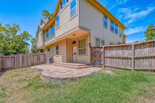 back of house with a yard, a patio, and cooling unit