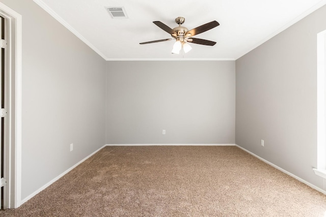 carpeted spare room featuring ceiling fan and crown molding