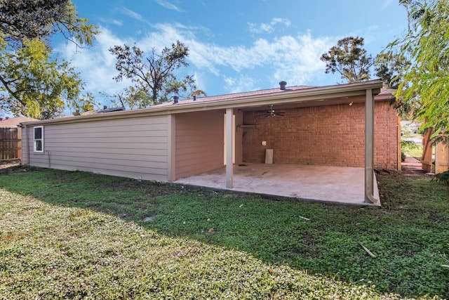 back of property featuring a patio, ceiling fan, and a lawn