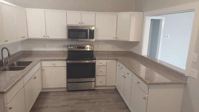 kitchen with white cabinetry, sink, and appliances with stainless steel finishes