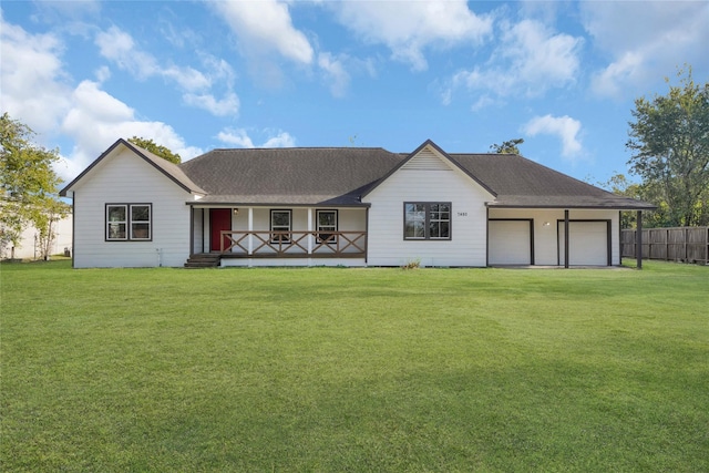 view of front of house featuring a garage, covered porch, and a front lawn