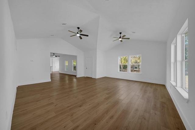 unfurnished living room with wood-type flooring and vaulted ceiling