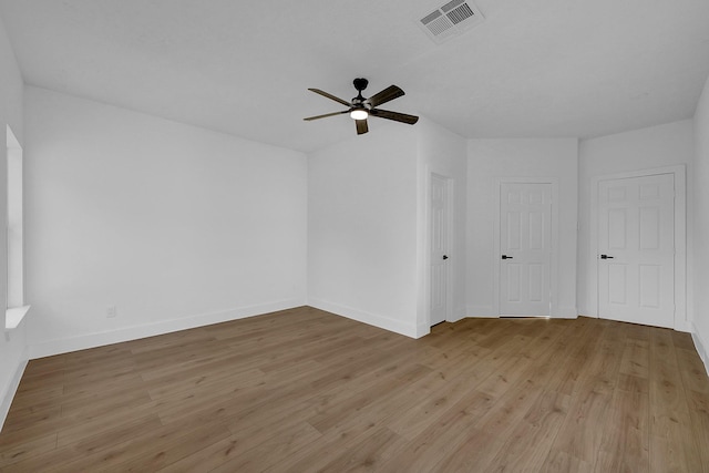 spare room with ceiling fan and light wood-type flooring