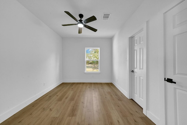 spare room with light wood-type flooring and ceiling fan