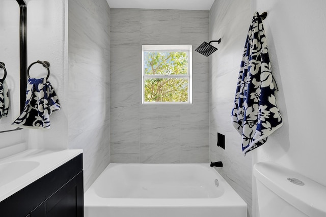 full bathroom with vanity, toilet, and tiled shower / bath