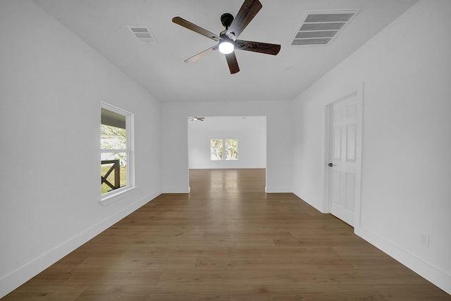 spare room featuring ceiling fan and dark wood-type flooring