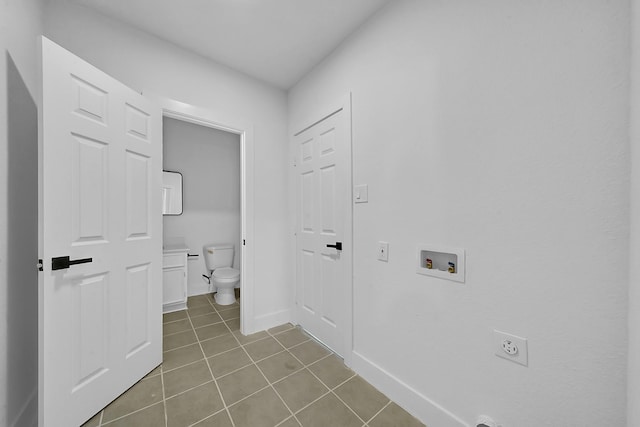 laundry area featuring hookup for an electric dryer, light tile patterned floors, and washer hookup