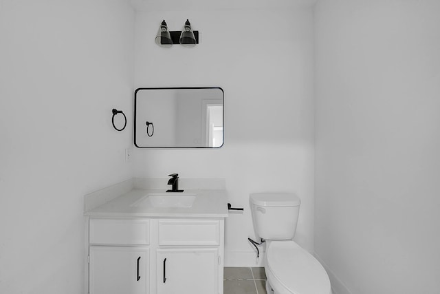 bathroom featuring tile patterned floors, vanity, and toilet