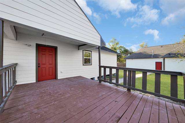 wooden terrace featuring a yard