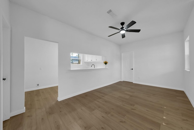 spare room featuring ceiling fan and light wood-type flooring