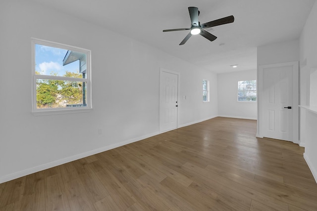 unfurnished room with hardwood / wood-style flooring and ceiling fan