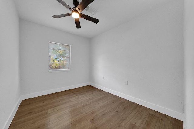 spare room with ceiling fan and wood-type flooring