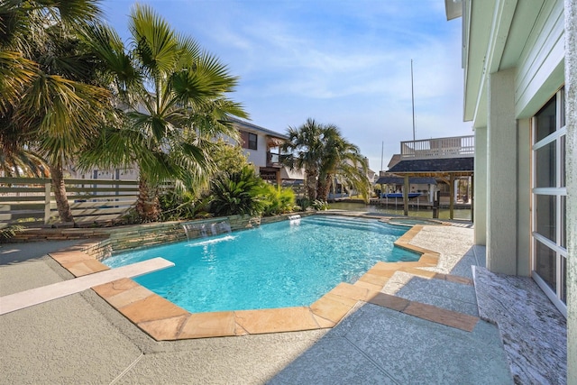 view of pool featuring pool water feature and a patio