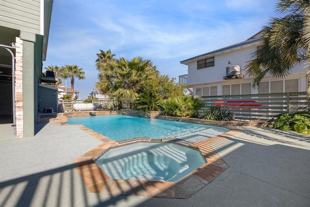 view of pool featuring an in ground hot tub, pool water feature, and a patio area