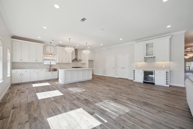 kitchen featuring wine cooler, white cabinetry, and a healthy amount of sunlight