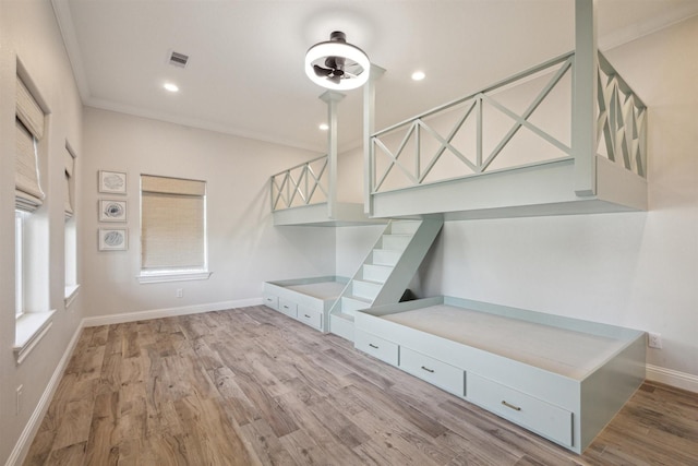 interior space featuring light hardwood / wood-style floors and crown molding