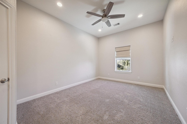 carpeted spare room featuring ceiling fan