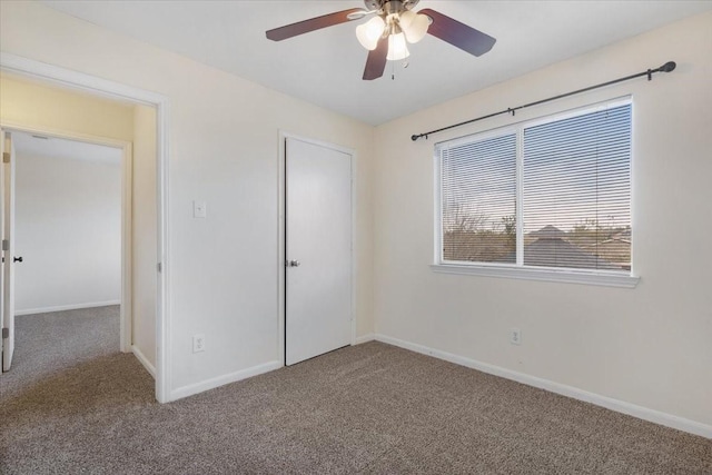 unfurnished bedroom featuring ceiling fan, a closet, and carpet floors