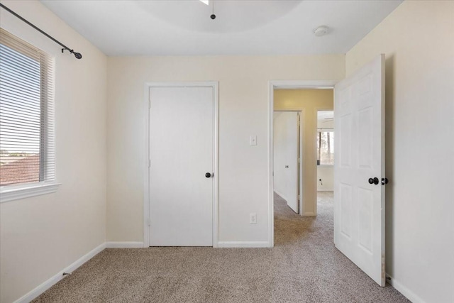 unfurnished bedroom with light carpet