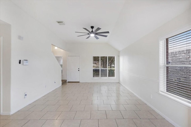 tiled spare room with ceiling fan and vaulted ceiling