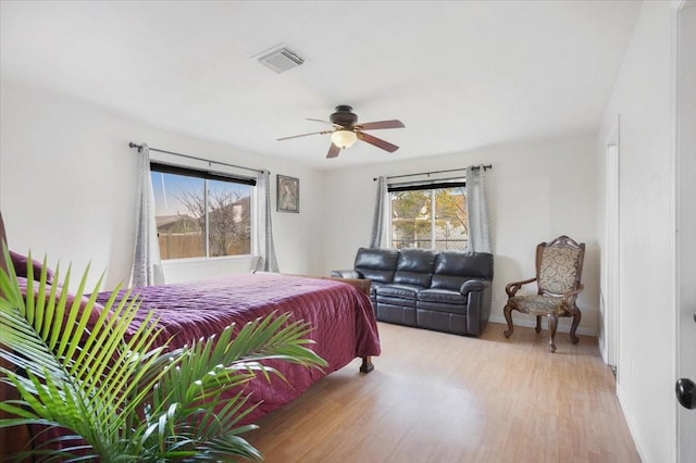 bedroom with ceiling fan and light wood-type flooring