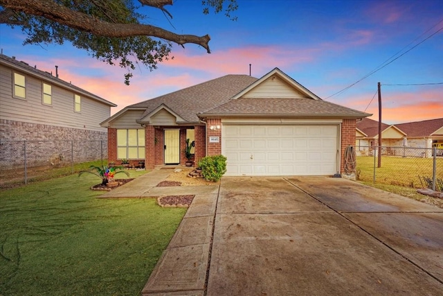 view of front of home featuring a garage and a yard