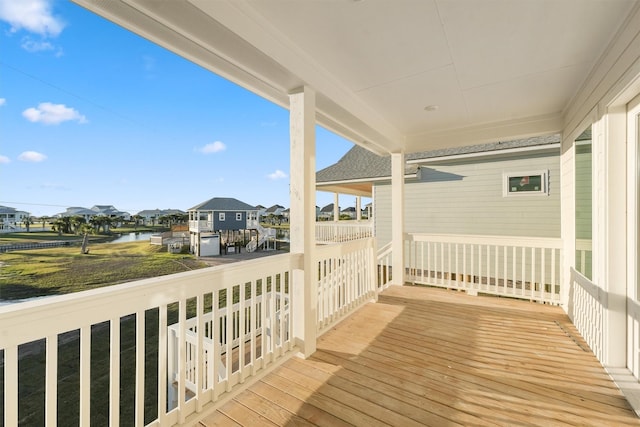 wooden terrace featuring a water view