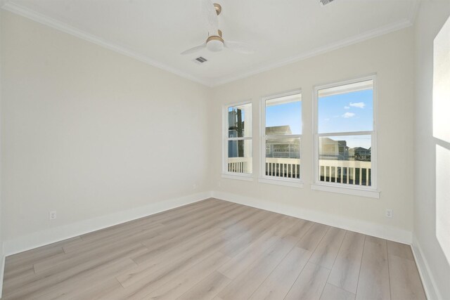 spare room with light hardwood / wood-style flooring, ceiling fan, and crown molding