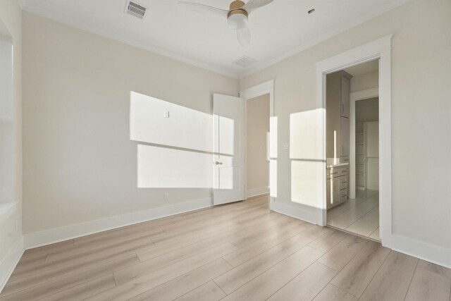 unfurnished bedroom featuring ensuite bathroom, ceiling fan, light hardwood / wood-style floors, and ornamental molding