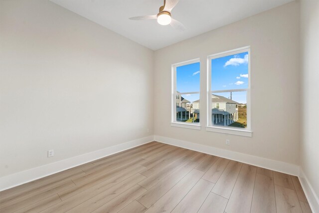 spare room featuring ceiling fan and light wood-type flooring