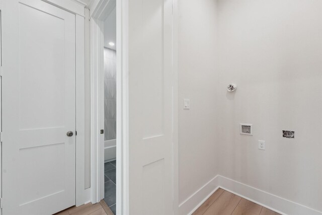 laundry area featuring washer hookup, electric dryer hookup, and light wood-type flooring