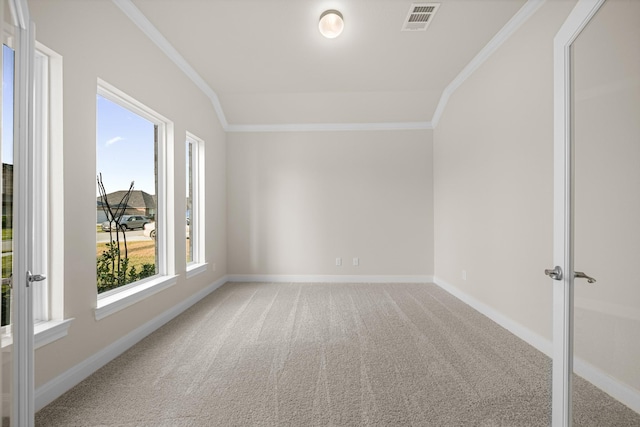 spare room featuring carpet, french doors, visible vents, ornamental molding, and baseboards