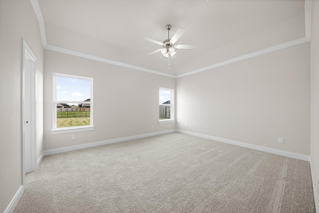 spare room with light carpet, a healthy amount of sunlight, and ornamental molding