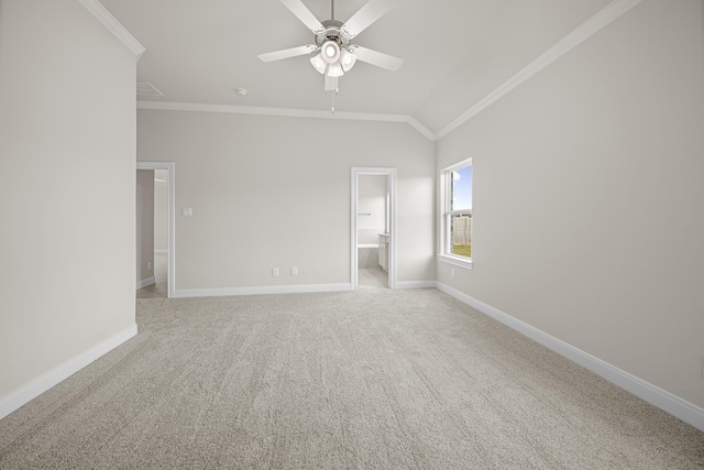 unfurnished bedroom featuring baseboards, ornamental molding, vaulted ceiling, and light colored carpet