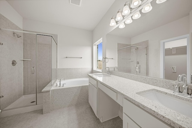 full bath with a garden tub, a stall shower, a sink, and tile patterned floors