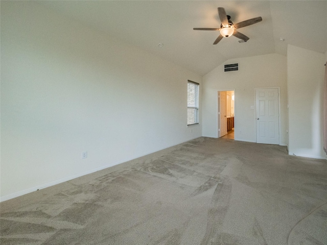 carpeted empty room featuring vaulted ceiling and ceiling fan