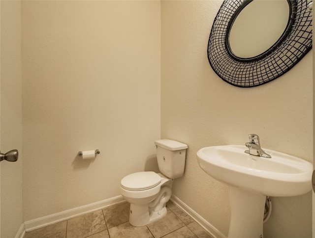 bathroom featuring sink, tile patterned flooring, and toilet