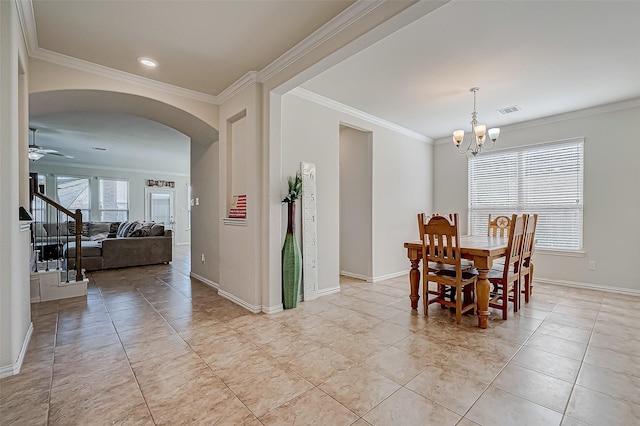 tiled dining space featuring ceiling fan with notable chandelier and ornamental molding