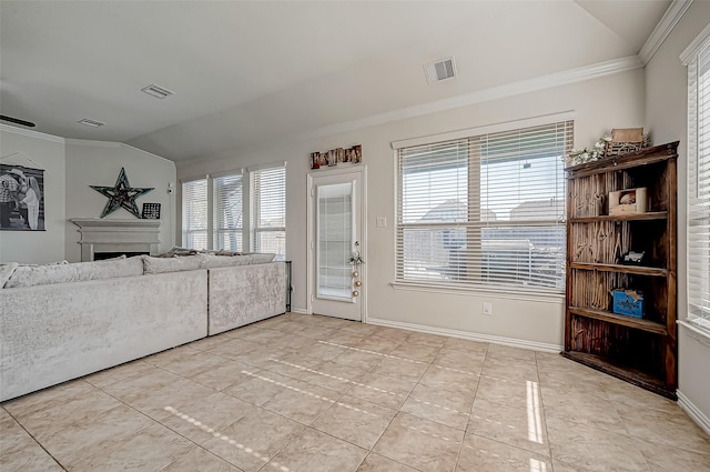 unfurnished living room with plenty of natural light, light tile patterned floors, and lofted ceiling