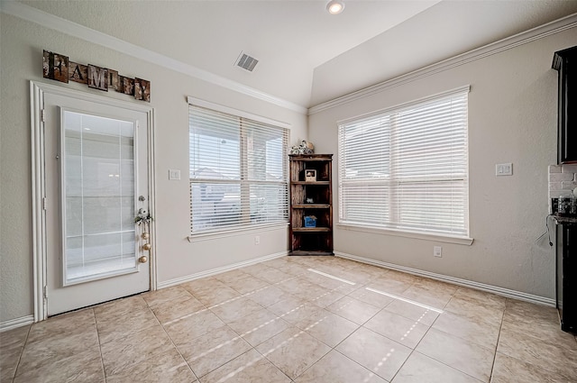 doorway to outside featuring light tile patterned floors, crown molding, and lofted ceiling