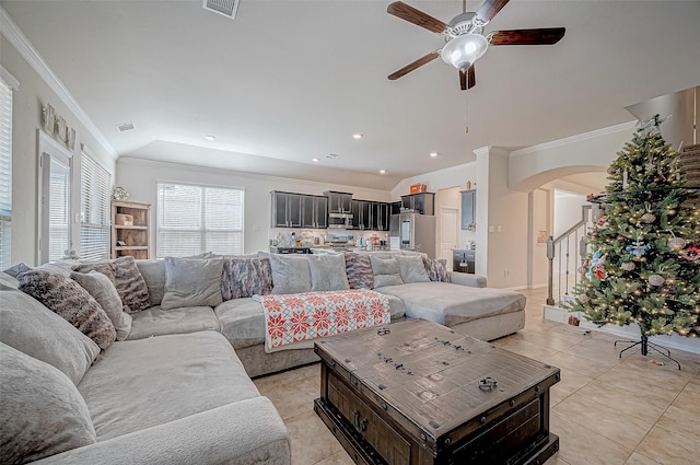 tiled living room with ceiling fan, vaulted ceiling, and ornamental molding