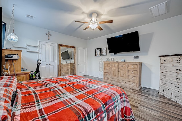 bedroom with ceiling fan and hardwood / wood-style floors