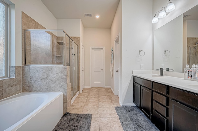 bathroom featuring tile patterned flooring, shower with separate bathtub, and vanity