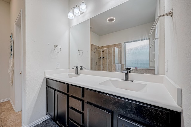 bathroom with tile patterned flooring, vanity, and walk in shower