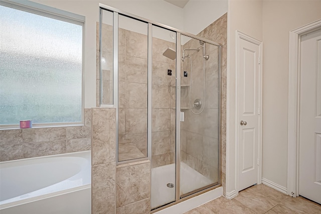 bathroom featuring a wealth of natural light, tile patterned flooring, and independent shower and bath