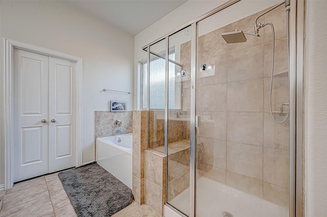 bathroom with separate shower and tub and tile patterned flooring