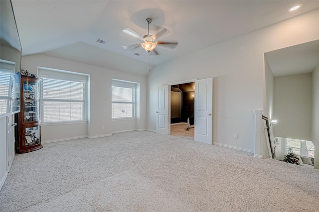 unfurnished bedroom featuring ceiling fan, light colored carpet, and vaulted ceiling