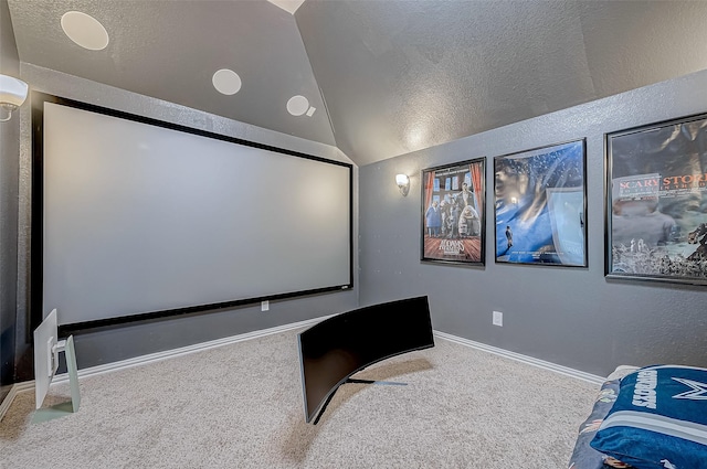 home theater featuring carpet, a textured ceiling, and lofted ceiling