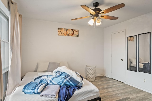 bedroom featuring ceiling fan and hardwood / wood-style floors