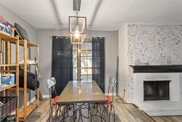 dining room featuring a fireplace and hardwood / wood-style floors